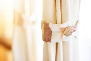 Vintage Wooden buttons on white cotton curtains photo