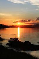 tradicion de largo cola barco y pescador en hermosa puesta de sol crepúsculo a khong río el tailandés-laos frontera chaingkhan distrito Tailandia foto