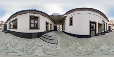 full seamless spherical hdri 360 panorama view on narrow street in yard between office buildings with arch in equirectangular projection, AR VR content photo