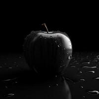 A wet black apple on black background photo