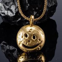 A necklace 24k gold with a round smiley cute face photo