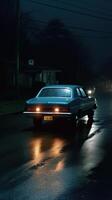 A realistic photograph of a classic 70s car driven at night photo