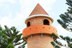 Beautiful brick stone tower is architecture roman stytle landmark in the garden and park at Thailand. photo