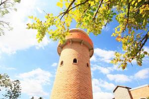 Beautiful brick stone tower is architecture roman stytle landmark in the garden and park at Thailand. photo