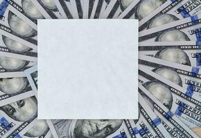 square white paper note on fan-shaped dollars photo