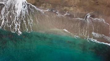 Top view of a deserted beach. Coast of the island of Tenerife. Aerial drone footage of sea waves reaching shore video