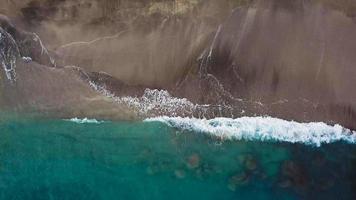 Top view of a deserted beach. Coast of the island of Tenerife. Aerial drone footage of sea waves reaching shore video