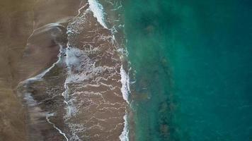 Top view of a deserted beach. Coast of the island of Tenerife. Aerial drone footage of sea waves reaching shore video