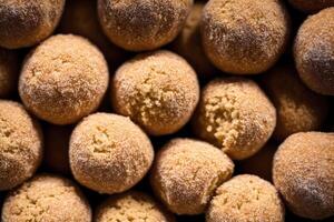 Sweet cookies in the shape of a ball sprinkled with powdered sugar on a wooden background. photo
