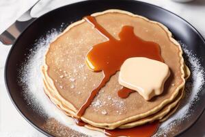 Stack of pancakes with maple syrup and sugar powder on a white plate. strawberries and whipped cream, photo