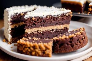 Piece of cake on a white plate on a wooden table. Homemade cake with nuts and honey. photo