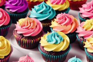 Colorful cupcakes on a white plate on a wooden table. Homemade cupcake with nuts and honey. photo