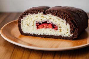 A swiss roll on a white plate on a wooden table. Homemade chocolate roll. Red velvet cake. photo