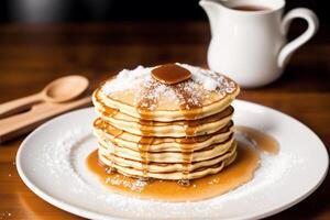Stack of pancakes with maple syrup and sugar powder on a white plate. strawberries and whipped cream, photo