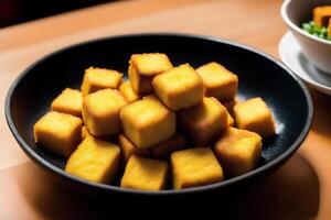 Tofu with sweet and sour sauce in a plate on wooden table. photo