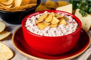 Potato chips in a bowl on a wooden background. photo