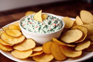 Potato chips in a bowl on a wooden background. photo