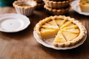 Delicious homemade tartlets on table, closeup. Delicious dessert. close up of a fresh baked apple tart. photo