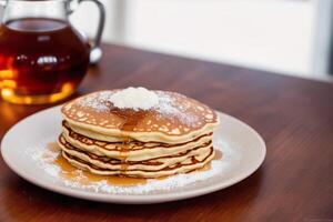 Stack of pancakes with maple syrup and sugar powder on a white plate. strawberries and whipped cream, photo