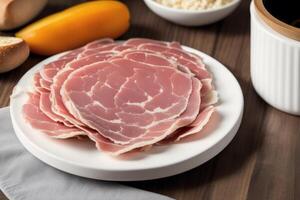 A plate of ham on the wooden table. photo