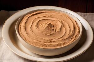 Cocoa Powder in a white bowl on a dark background. photo