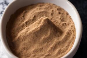 Cocoa Powder in a white bowl on a dark background. photo