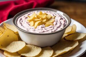 Potato chips in a bowl on a wooden background. photo