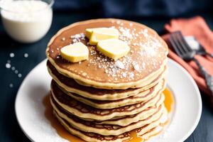 Stack of pancakes with maple syrup and sugar powder on a white plate. strawberries and whipped cream, photo