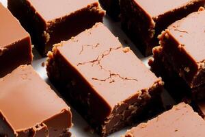 Fudge on a white plate on a wooden table. Homemade fudge cookies, candies with nuts. photo