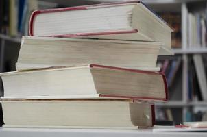 Old dirty books on the table. Books blurred background. photo