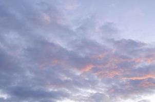 Blue sky and fluffy clouds. Beautiful cloudscape background. Sunlight on the clouds. Blue gradient. photo