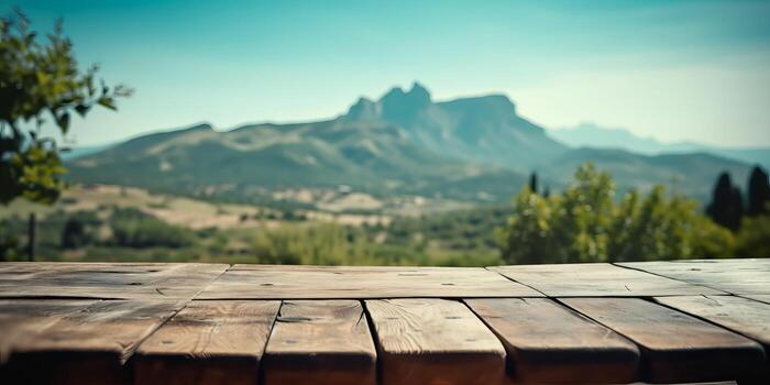 Empty wooden table with green mountain background, Free space for product display. photo
