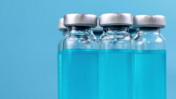 A macro shot of glass vials with blue coloured liquid video