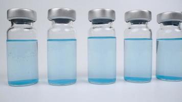 A macro shot of glass vials with blue coloured liquid video