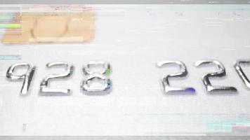 Panning shot of credit card numbers on a blue bank payment card video