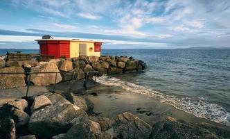 Beautiful coastal scenery with beach house on sandy Salthill beach in Galway, Ireland photo