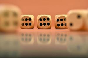 Closeup shot of wooden dices with numbers reflected in shiny surface photo