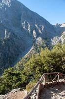 Views in the mountains along the path through the gorge sunny day. View of Gorge, a gorge in the Mountains of Greece, lying on the slopes of Mountains, one of the deepest gorges in the world. photo