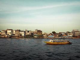 Boat and buildings in Bangkok photo