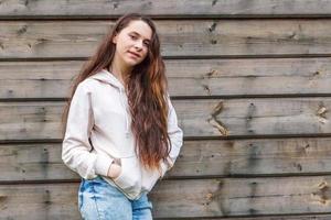 Happy girl smiling. Beauty portrait young happy positive laughing brunette woman on wooden wall background photo