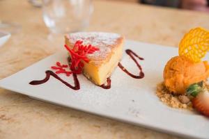 Cheese cake and orange ice cream to share photo