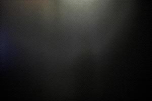 Black Punched Metal Sheet Wall Texture Background. photo