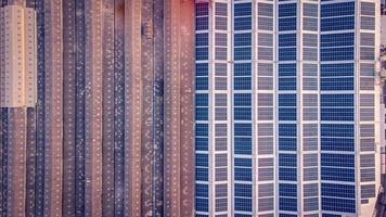 A large solar cell roof on an industrial building Generating electricity for the plant during daytime according to policies and measures to reduce global warming by taking high-angle shots from drones photo