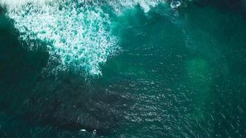 Top view of waves and two surfers on the surface of the Atlantic Ocean off the coast of Tenerife, Canary Islands, Spain video