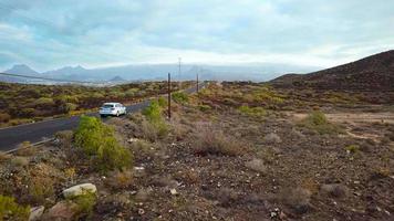Aerial shoot of a car rides along a desert road video