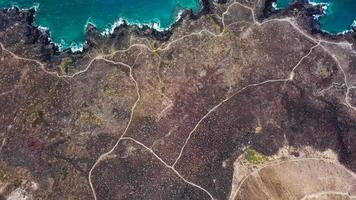 Top view of a deserted coast. Rocky shore of the island of Tenerife. Aerial drone footage of sea waves reaching shore video