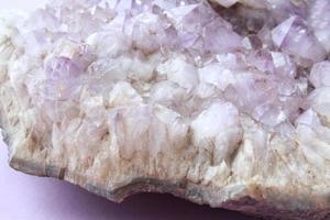 Natural violet amethyst druse geode mineral crystal unpolished semi-precious gemstone. Magic rock for ritual, witchcraft, spiritual practice, meditation. Esoteric life balance concept. Copy space photo