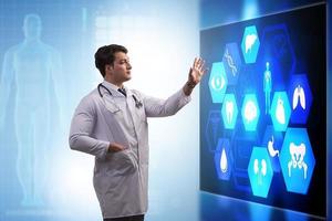Medicine doctor and stethoscope in hand touching icon medical network connection with modern virtual screen interface, medical technology network concept and two doctor photo