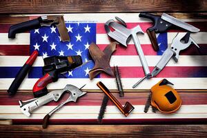 Happy labor day, American flag and tools near the helmet labor day concept. photo