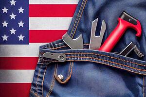 Set of tools and american flag in jeans pocket. labor day background concept. photo